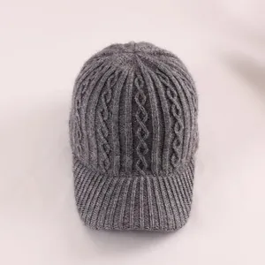Close-up of gray knit baseball cap showing textured diamond patterns and fuzzy material