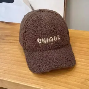 Detail of UNIQUE embroidery on deep brown faux shearling warm winter baseball cap