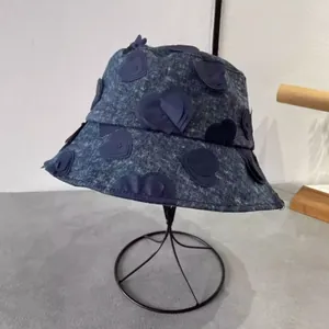 Deep blue denim bucket hat with 3D heart embroidery for women in a stylish casual design