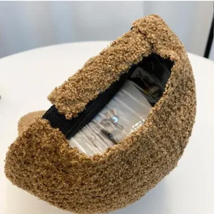 Detail of warm brown teddy fleece baseball cap showing soft texture and inner lining