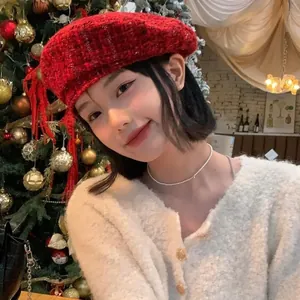 Detail of red tweed beret featuring visible texture and fringe for a festive winter look