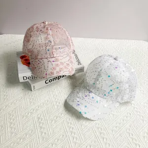 Close-up of mesh baseball caps with floral appliques and iridescent sequins for women