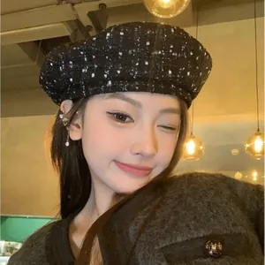 Close-up of black and silver wool tweed beret hat texture on fashion model