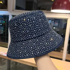 Macro detail of dark blue denim bucket hat with sparkling rhinestones and wide brim