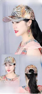 Detail of maple-toned baseball cap featuring floral embroidery, pearls and rhinestones