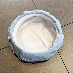 Detailed view of light blue denim beret with 3D heart patches and inner adjustment strap