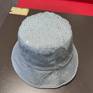 Detail of light blue denim bucket hat with sparkling silver rhinestones and flat top