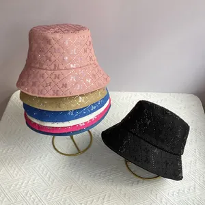 Close-up showing colorful rhinestone bucket hats with quilted texture and letter N detail
