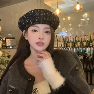 Detailed close-up of black tweed beret with elegant wool texture for autumn outfits