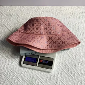 Pink sun hat detail showing letter M rhinestone pattern on brim and 109g weight on scale
