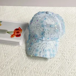 Detailed close-up of light blue mesh baseball cap with 3D floral petals and sequins