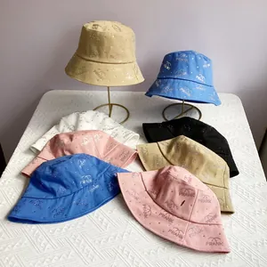 Detail of rhinestone PRANK lettering and palm tree pattern on various colored sun hats