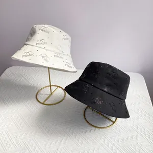 Fashionable black and white bucket hats with rhinestone FRANK letter patterns