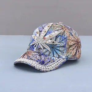 Detail of baseball cap with floral print, white pearls, and leaf rhinestone patch