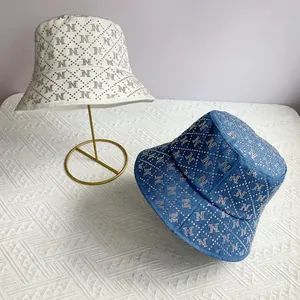Luxe wide brim bucket hat with rhinestone N pattern in beige and denim blue