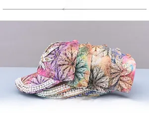 Detailed view of women baseball cap featuring floral prints and handmade pearl decorations