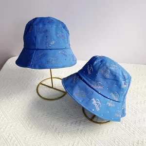 Stylish blue canvas bucket hat with rhinestone letters and heart patterns for sun protection