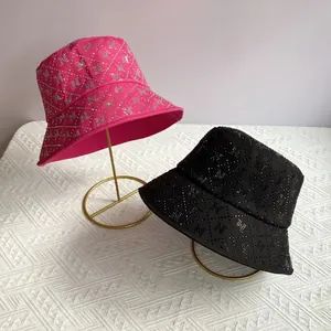 Chic wide brim fisherman hats in pink and black with rhinestone N patterns and diamond quilting