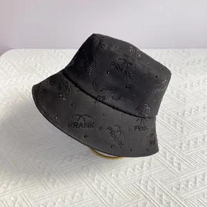 Detail of black bucket hat with sparkling rhinestones forming a Prank letter pattern