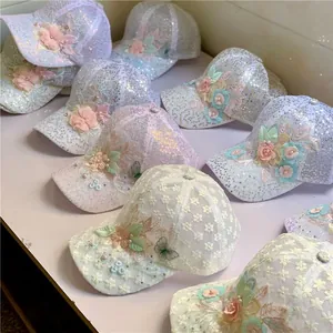 Close-up of lace embroidery, sequins, and floral patterns on breathable baseball caps