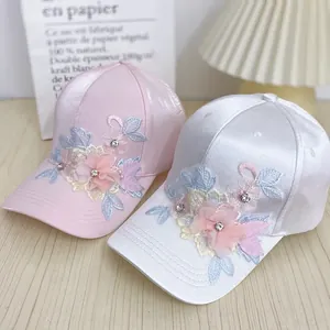 Silky baseball caps for women featuring 3D floral embroidery and sparkling rhinestones