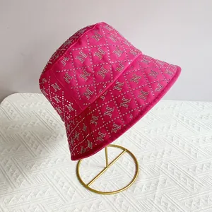Detailed view of fuchsia cotton bucket hat with silver rhinestone letter N pattern