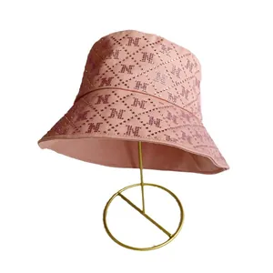 Pink sun hat bucket hat with rhinestone letter M pattern on gold metal stand