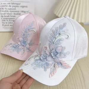 Silk-like satin baseball caps with elegant floral embroidery and pearl accents
