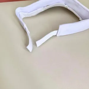 Detail view of the white sun visor showing the adjustable Velcro strap for custom fit