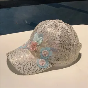 Detail of silver sequins and 3D floral embroidery with pearls on white mesh baseball cap