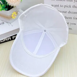 Detailed interior of a white silk-satin baseball cap with sweatband and wash label