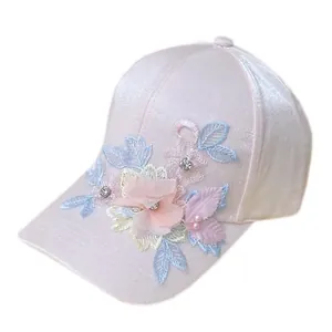 Pink silk-like baseball cap featuring 3D floral appliques with pearls and rhinestones