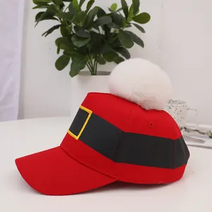 Red Christmas baseball cap with white pom pom and Santa belt design for festive winter style