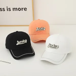 Close-up of three baseball caps with Sunday embroidery and rhinestone trim on the brim