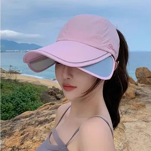 Detail of pink sun hat with retractable side brims and embroidery for outdoor protection