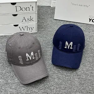 Washed cotton baseball caps in dark grey and navy with M embroidery and distressed details