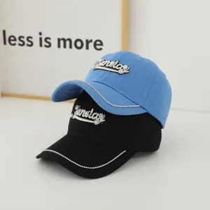 Blue and black baseball caps with rhinestone Sunday embroidery and studded brim