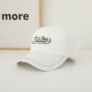 Close-up of the Sunday rhinestone embroidery and sparkling crystals on white baseball cap