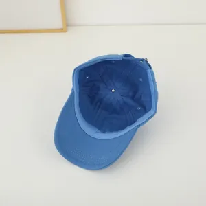 Inside view of blue baseball cap showing six-panel stitch detail and metal buckle strap