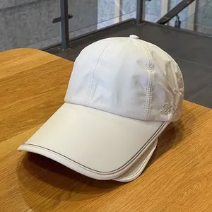 Close-up of white sun hat with embroidery detail on lightweight quick-dry fabric