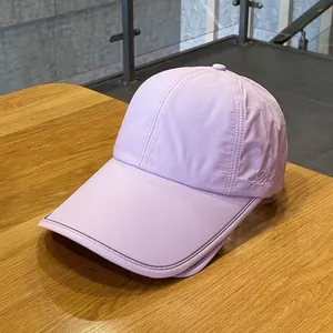 Close-up of lavender quick-dry baseball cap with Dolly embroidery and reflective brim edge