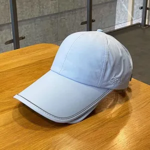 Close-up of light blue ponytail baseball cap with Dallaue embroidery on quick-dry fabric