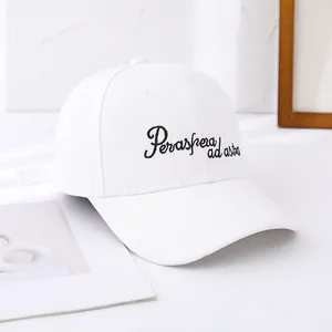 Detail of white cotton baseball cap with black embroidered Per aspera ad astra lettering