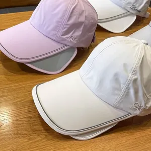 Detail of extendable sun visor and reflective trim on ponytail baseball caps