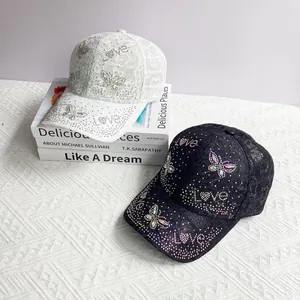 Detail view of lace baseball caps with rhinestone butterfly and Love lettering design