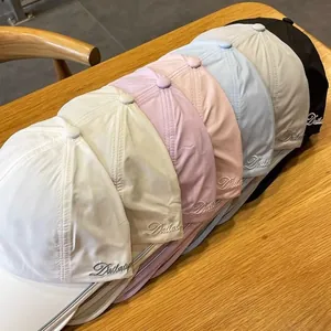 Detailed display of colorful baseball caps with side embroidery on wood background