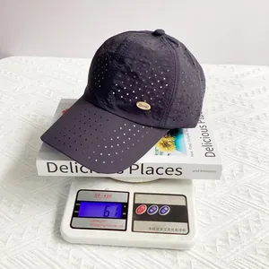 Detailed view of ultra-light 61g weight of grey breathable laser-cut baseball cap