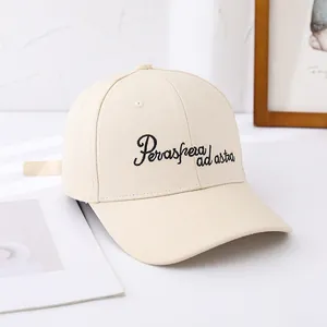 Close-up of cream canvas baseball cap featuring Per aspera ad astra black embroidery