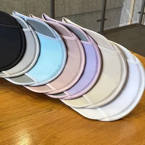 Detail of multi-color sun hat brims in mesh fabric showing seven color options on wood