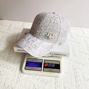 Macro detail of lavender lace baseball cap with sparkling rhinestones and floral badge